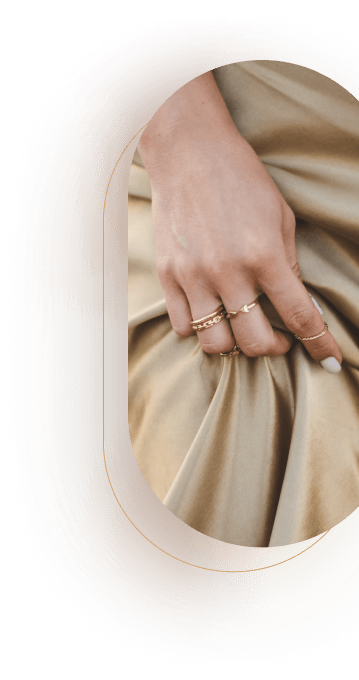 Women hand with gold dainty stacking rings and midi ring