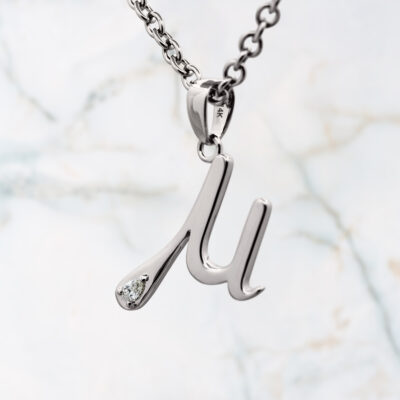 Greek Mu pendant accented with a diamond
