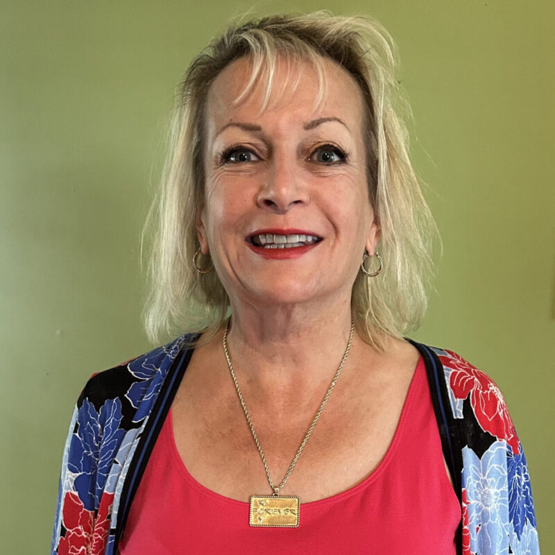 Karen wearing her custom tribute pendant to Roy