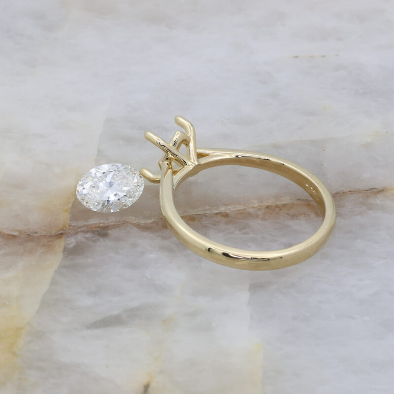 Loose oval diamond and delicate 18K yellow gold ring mount.