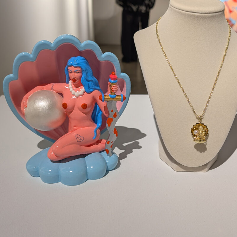 Oceana’s Pearl Pendant displayed beside sculptural artwork at Corey Helford Gallery.