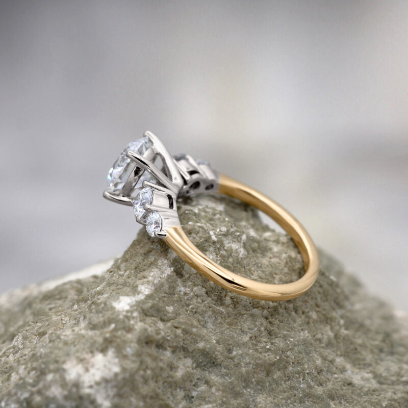 Platinum setting to enhance the white stones on a yellow gold band
