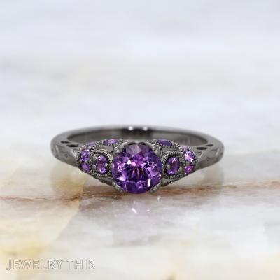 Black rhodium bridal ring with round purple center stone and decorative filigree accents.