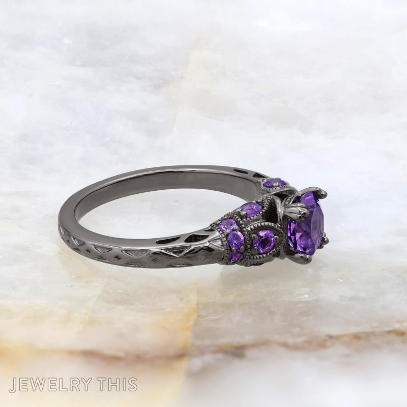 Black rhodium bridal ring with round purple center stone and decorative filigree accents.