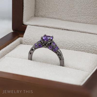 Black rhodium bridal ring with round purple center stone and decorative filigree accents.
