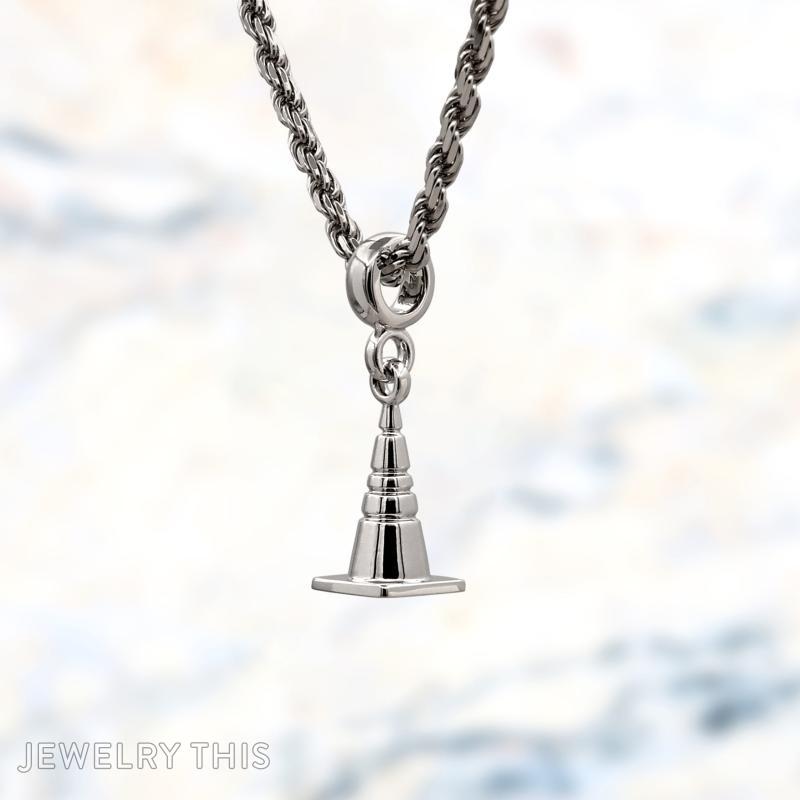 Three-dimensional silver charms shaped as a number block, roller skate, and construction cone.