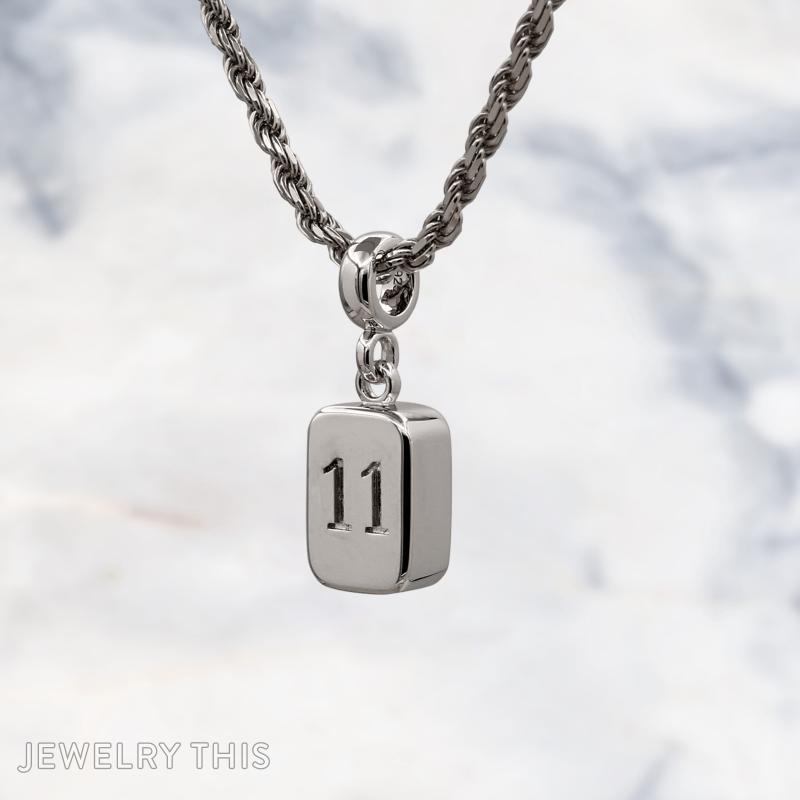 Three-dimensional silver charms shaped as a number block, roller skate, and construction cone.