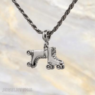 Three-dimensional silver charms shaped as a number block, roller skate, and construction cone.