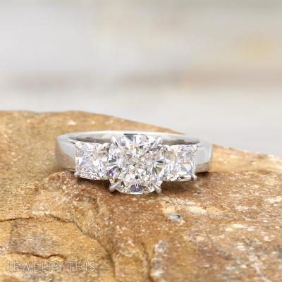 cushion cut diamond three stone ring