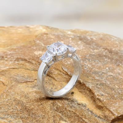 cushion cut diamond three stone ring